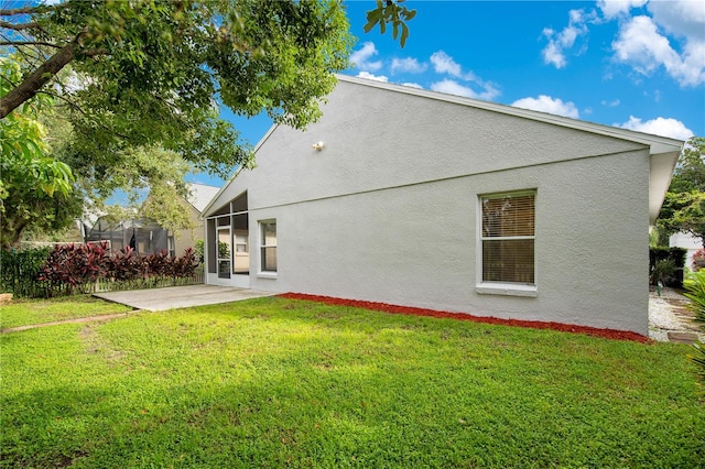 rear view of house featuring a patio and a yard