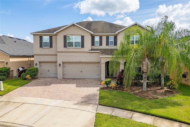 view of front of house with a garage and a front lawn