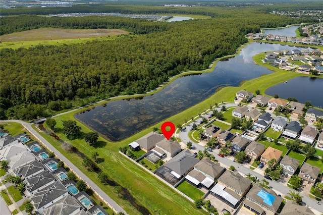 birds eye view of property featuring a residential view, a wooded view, and a water view