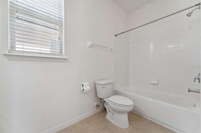 bathroom with tile patterned flooring, bathing tub / shower combination, toilet, and baseboards