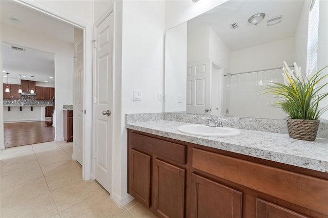 full bathroom featuring tile patterned floors, visible vents, vanity, and decorative backsplash