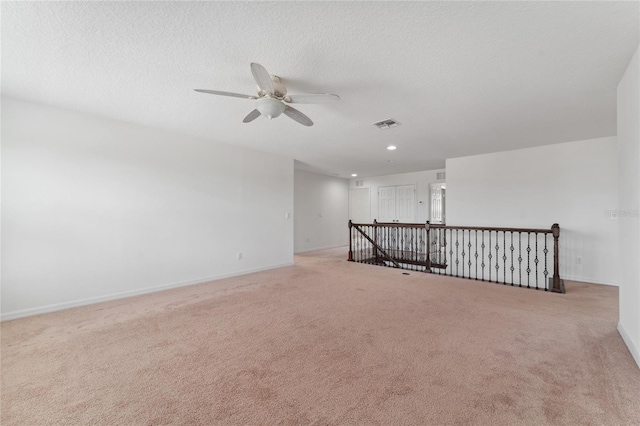 empty room with recessed lighting, baseboards, carpet floors, and a textured ceiling