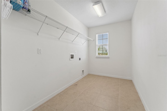 laundry room featuring electric dryer hookup, light tile patterned floors, baseboards, hookup for a washing machine, and laundry area