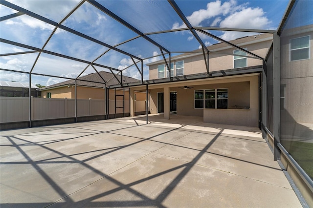 rear view of property featuring a patio, a lanai, and stucco siding