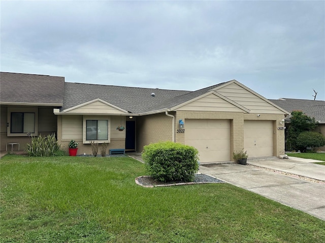 ranch-style home featuring a garage and a front lawn