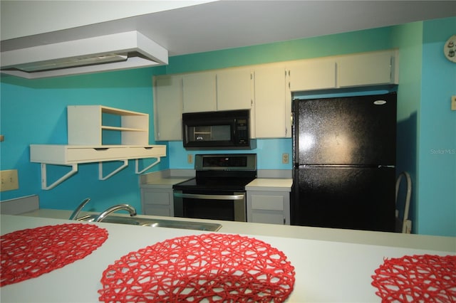 kitchen featuring white cabinets, black appliances, and sink