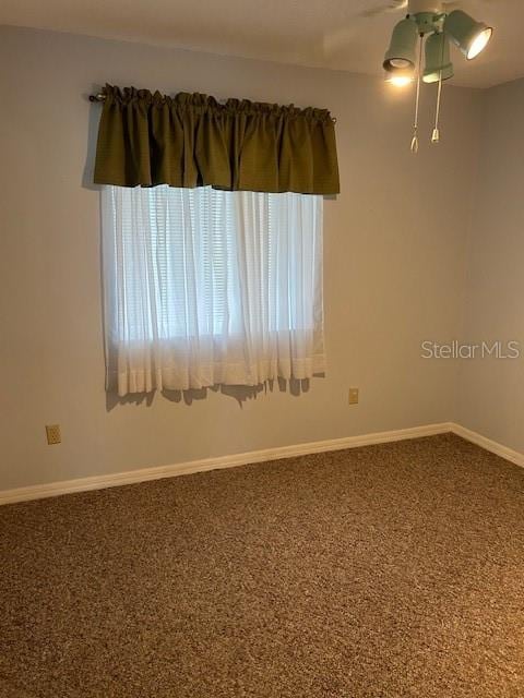 empty room featuring carpet floors and ceiling fan