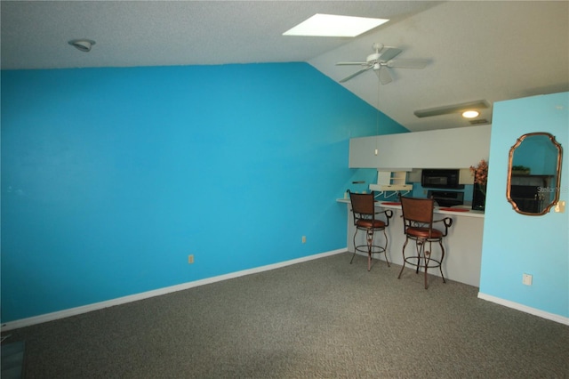 unfurnished office with ceiling fan, lofted ceiling, and carpet flooring