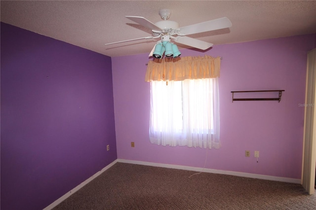 carpeted empty room featuring a textured ceiling and ceiling fan