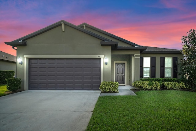 view of front of home with a lawn and a garage