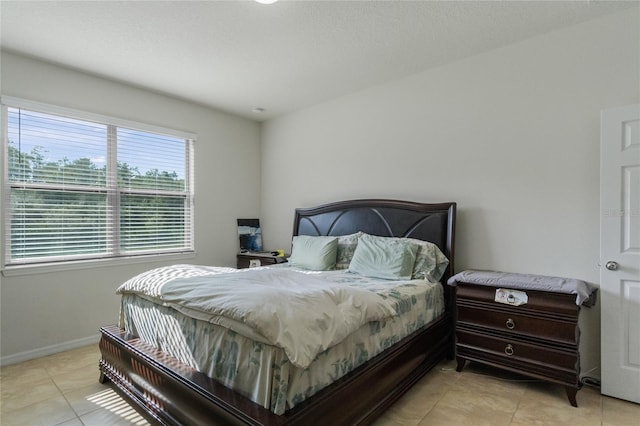 bedroom featuring light tile patterned flooring