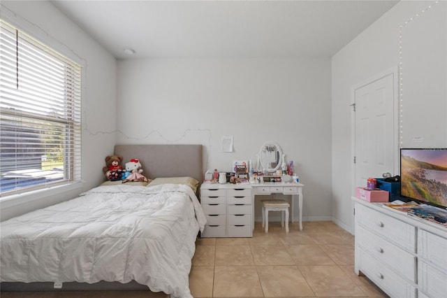 bedroom with light tile patterned floors