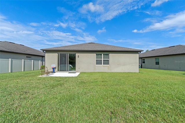 back of house featuring a yard and a patio area