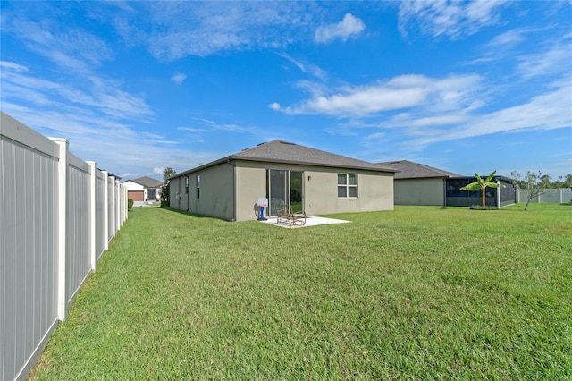 back of property featuring a lawn