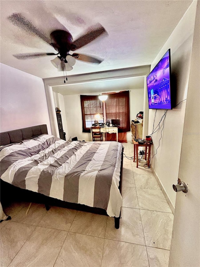 bedroom featuring a textured ceiling and ceiling fan