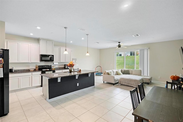 1820 Holden Ridge Ln, Clermont, FL 34715 - kitchen featuring light tile patterned flooring, white cabinets, black appliances, and ceiling fan
