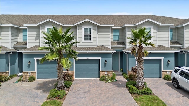 1820 Holden Ridge Ln, Clermont, FL 34715 - multi unit property with an attached garage, stone siding, driveway, and roof with shingles