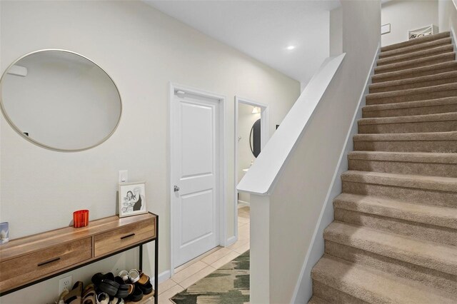 staircase with tile patterned floors