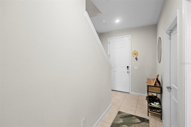 hall with light tile patterned floors