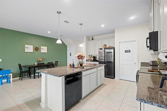 kitchen with a center island with sink, black appliances, pendant lighting, sink, and white cabinetry