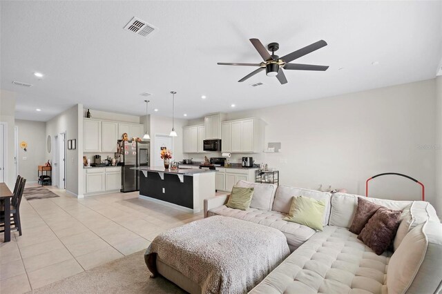 tiled living room with ceiling fan