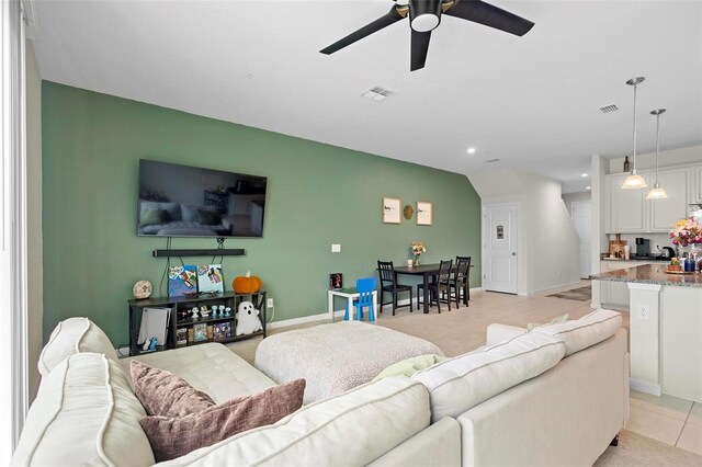 living room featuring ceiling fan and light tile patterned floors