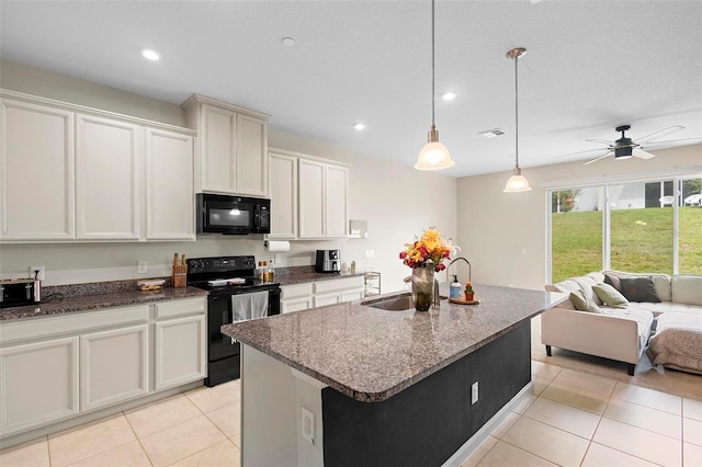 1820 Holden Ridge Ln, Clermont, FL 34715 - kitchen with visible vents, black appliances, an island with sink, a sink, and open floor plan