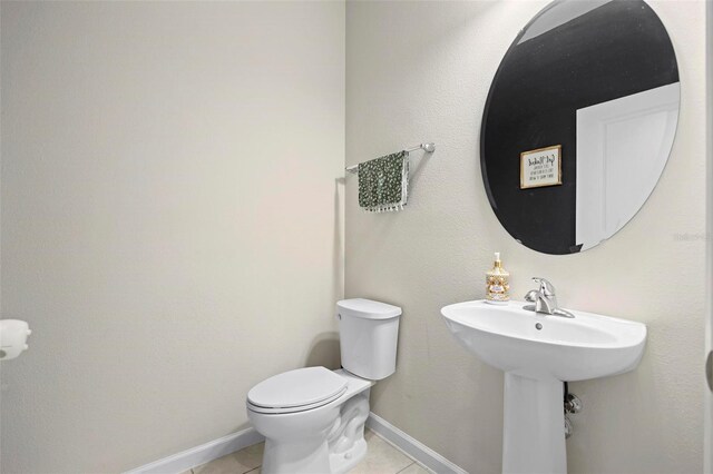 bathroom featuring tile patterned flooring and toilet