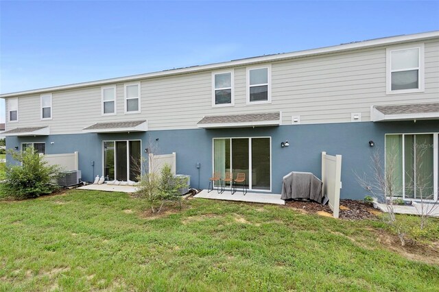 1820 Holden Ridge Ln, Clermont, FL 34715 - back of house featuring a lawn and stucco siding