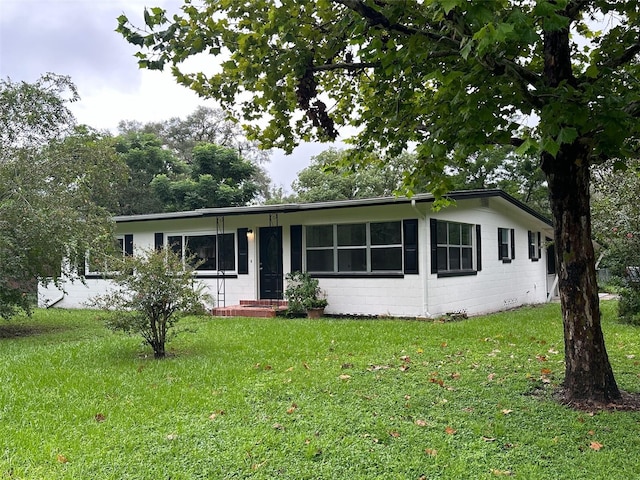 ranch-style house with a front lawn