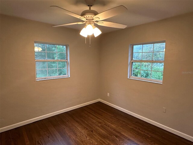 unfurnished room with dark hardwood / wood-style flooring and ceiling fan