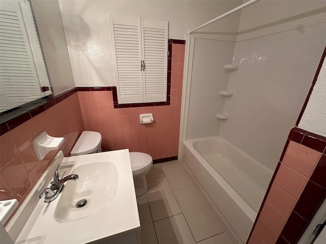 full bathroom with vanity, toilet, tile walls, and  shower combination