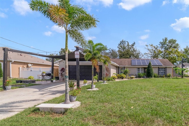 view of front facade featuring solar panels and a front yard