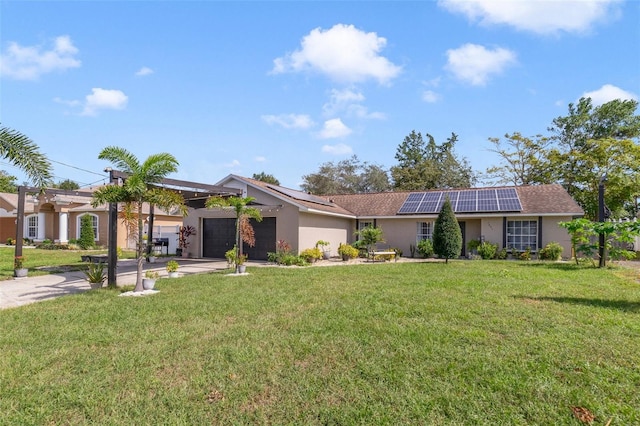 single story home with solar panels, a front yard, and a garage