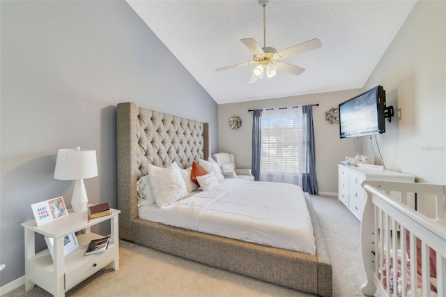 bedroom featuring a textured ceiling, ceiling fan, light colored carpet, and vaulted ceiling