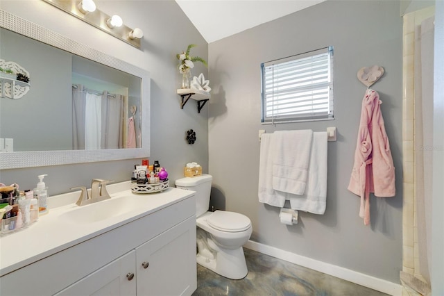 bathroom featuring vanity, vaulted ceiling, toilet, and walk in shower