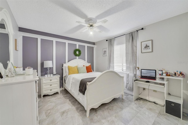 bedroom featuring a textured ceiling and ceiling fan