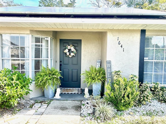 view of exterior entry with solar panels