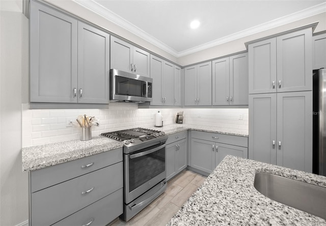 kitchen with stainless steel appliances and light stone countertops