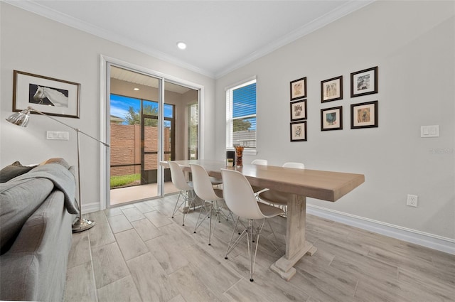 dining area with light hardwood / wood-style floors and crown molding