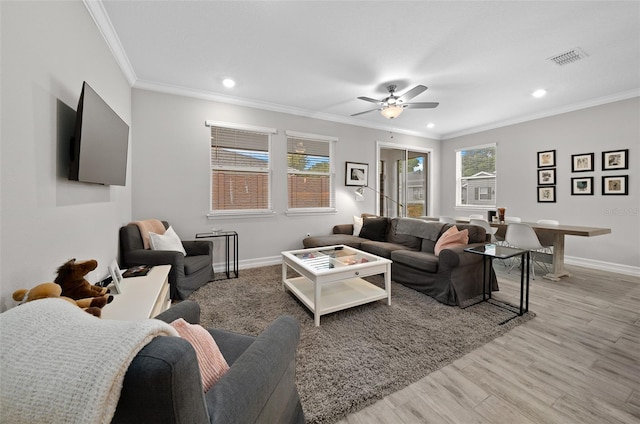 living room with ceiling fan, ornamental molding, and light hardwood / wood-style floors