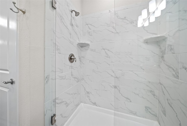 bathroom with a tile shower