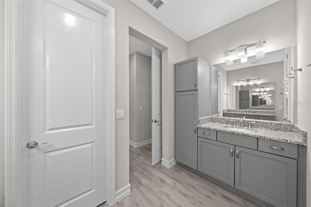 bathroom with vanity and hardwood / wood-style flooring