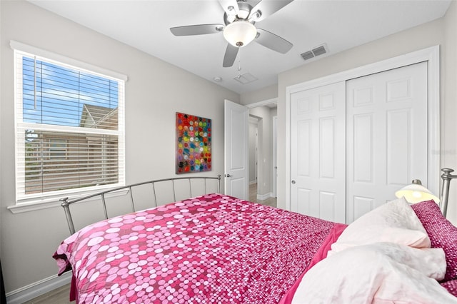 bedroom featuring ceiling fan, a closet, and hardwood / wood-style flooring