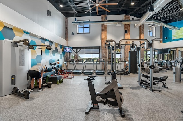 workout area featuring high vaulted ceiling