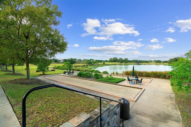 view of community with a water view and a lawn