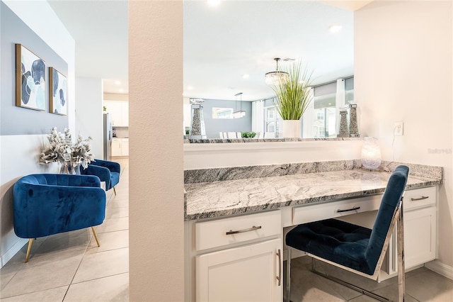 kitchen featuring white cabinetry, a healthy amount of sunlight, and light tile patterned flooring