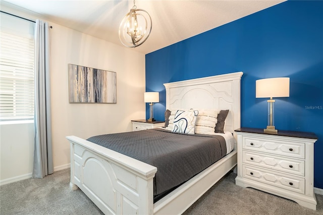 carpeted bedroom with a chandelier