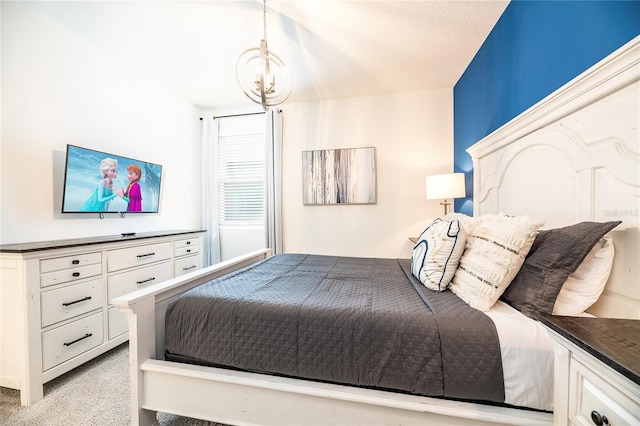 carpeted bedroom featuring a notable chandelier