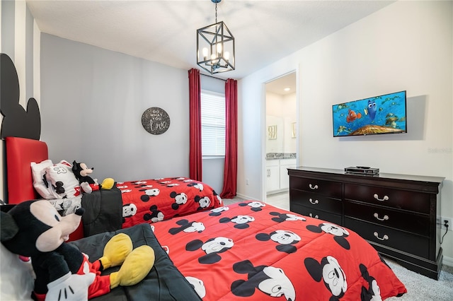 carpeted bedroom with a chandelier and ensuite bath